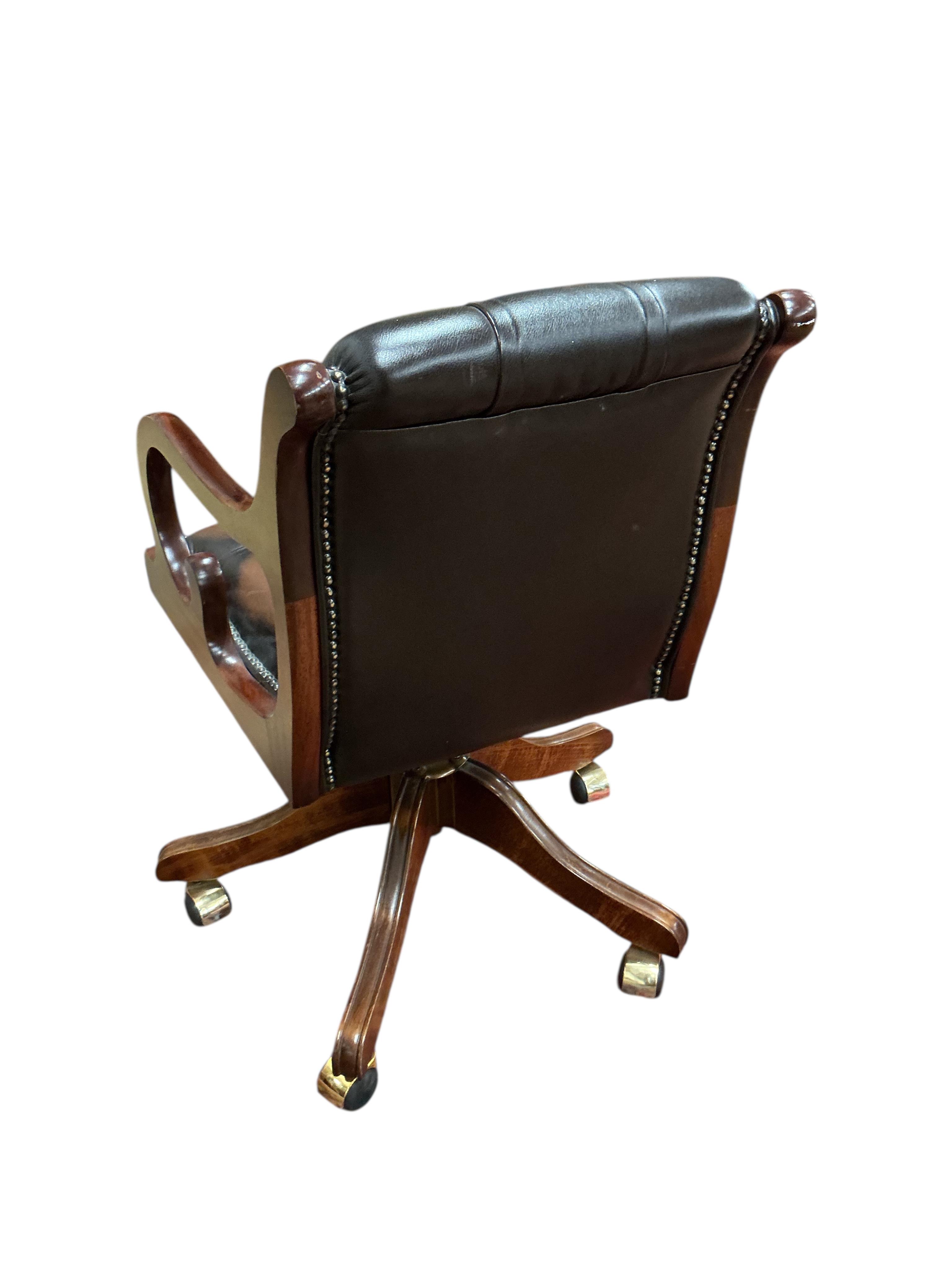 A reproduction buttoned brown leather swivel desk chair, width 51cm, depth 47cm, height 82cm